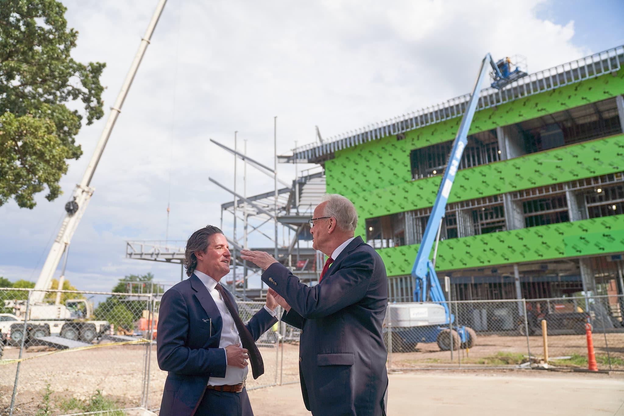 U.S. Senator Jerry Moran visits with 最火的十个赌博软件 President 迈克尔·施耐德 outside of the construction site for the new Campus Commons.